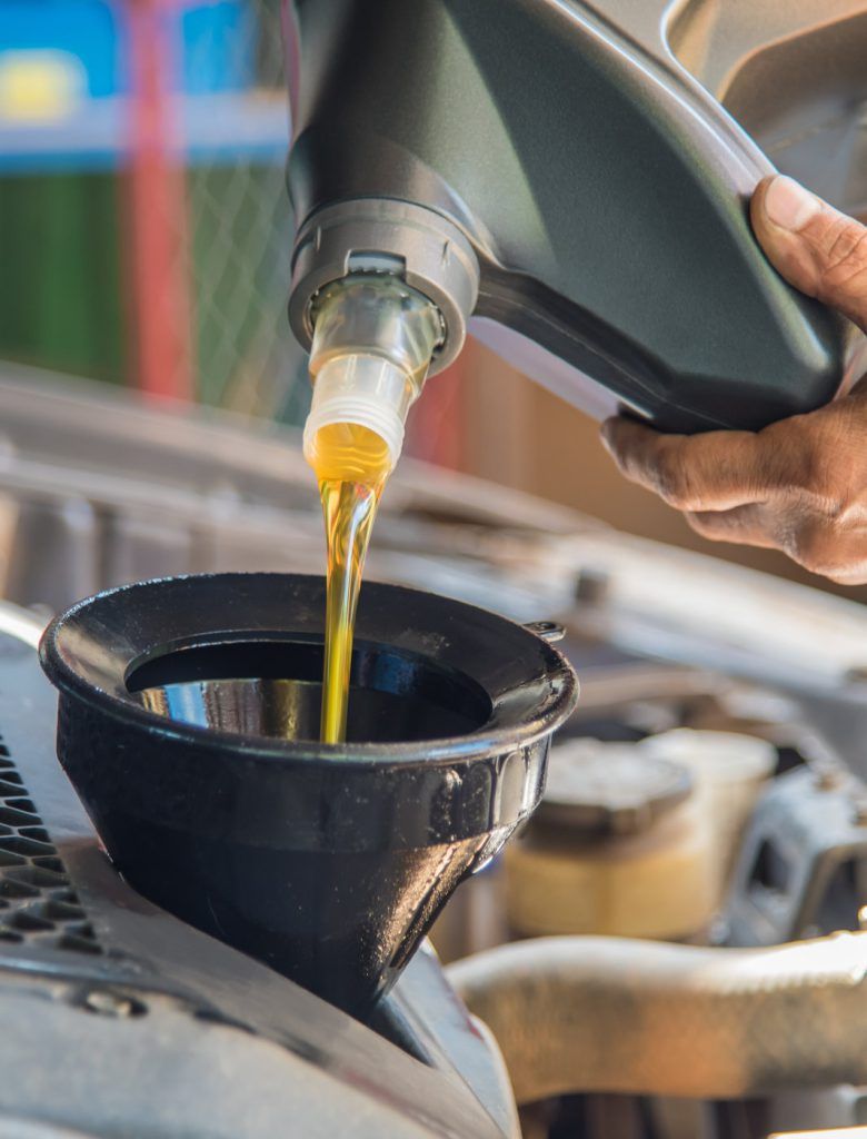 Mechanic pouring engine oil into a vehicle - Car Servicing Wellingborough